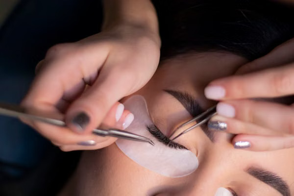 Beautician applying eyelash extensions